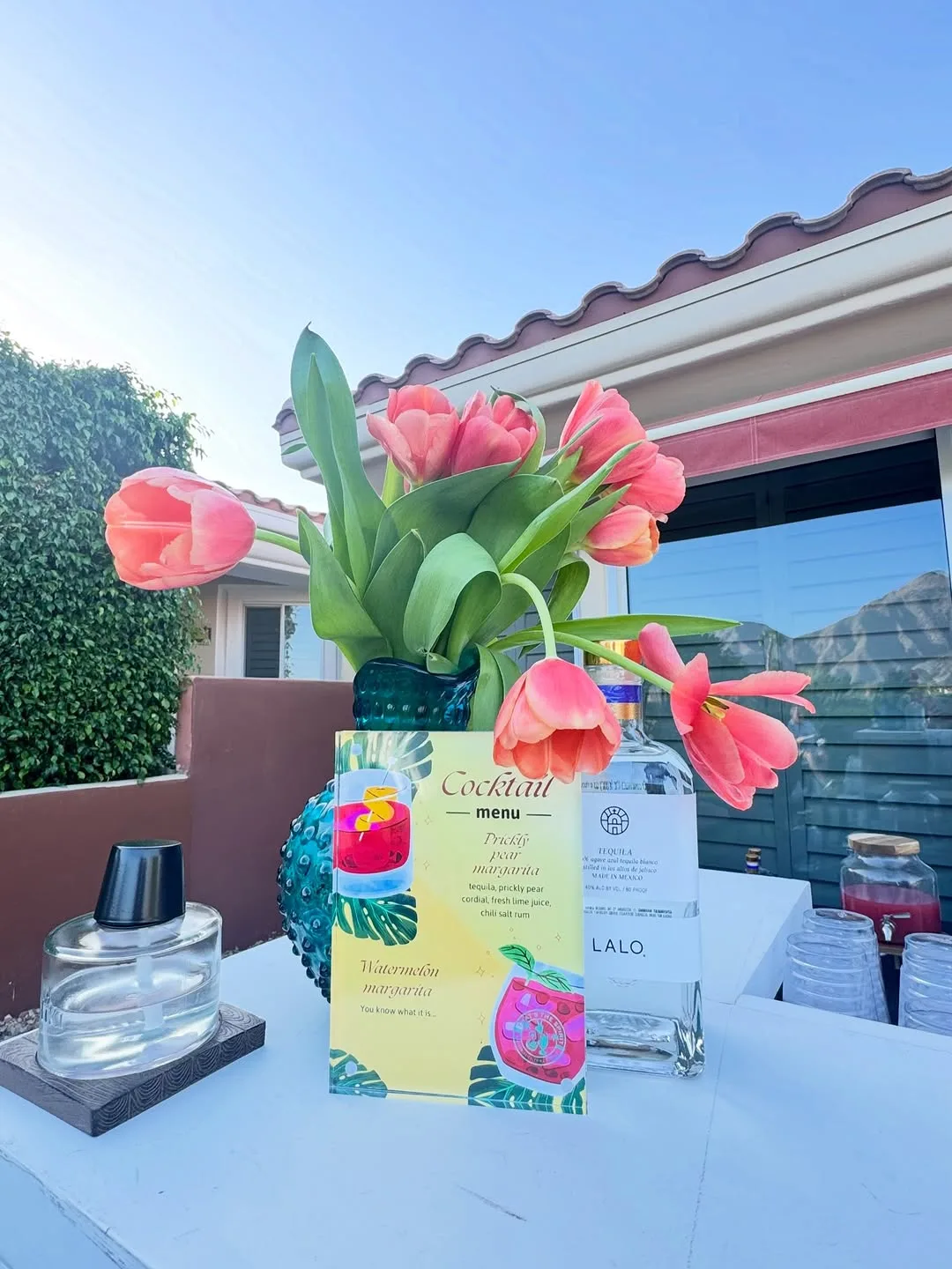 Cocktail menu and fresh flowers at a bachelorette catering event