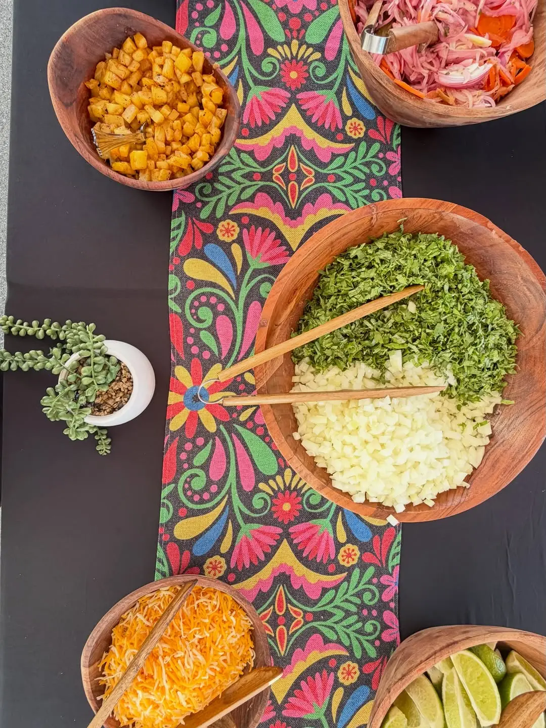 Colorful TacoNTodo garnish bar with fresh salsas at an Indio catering event
