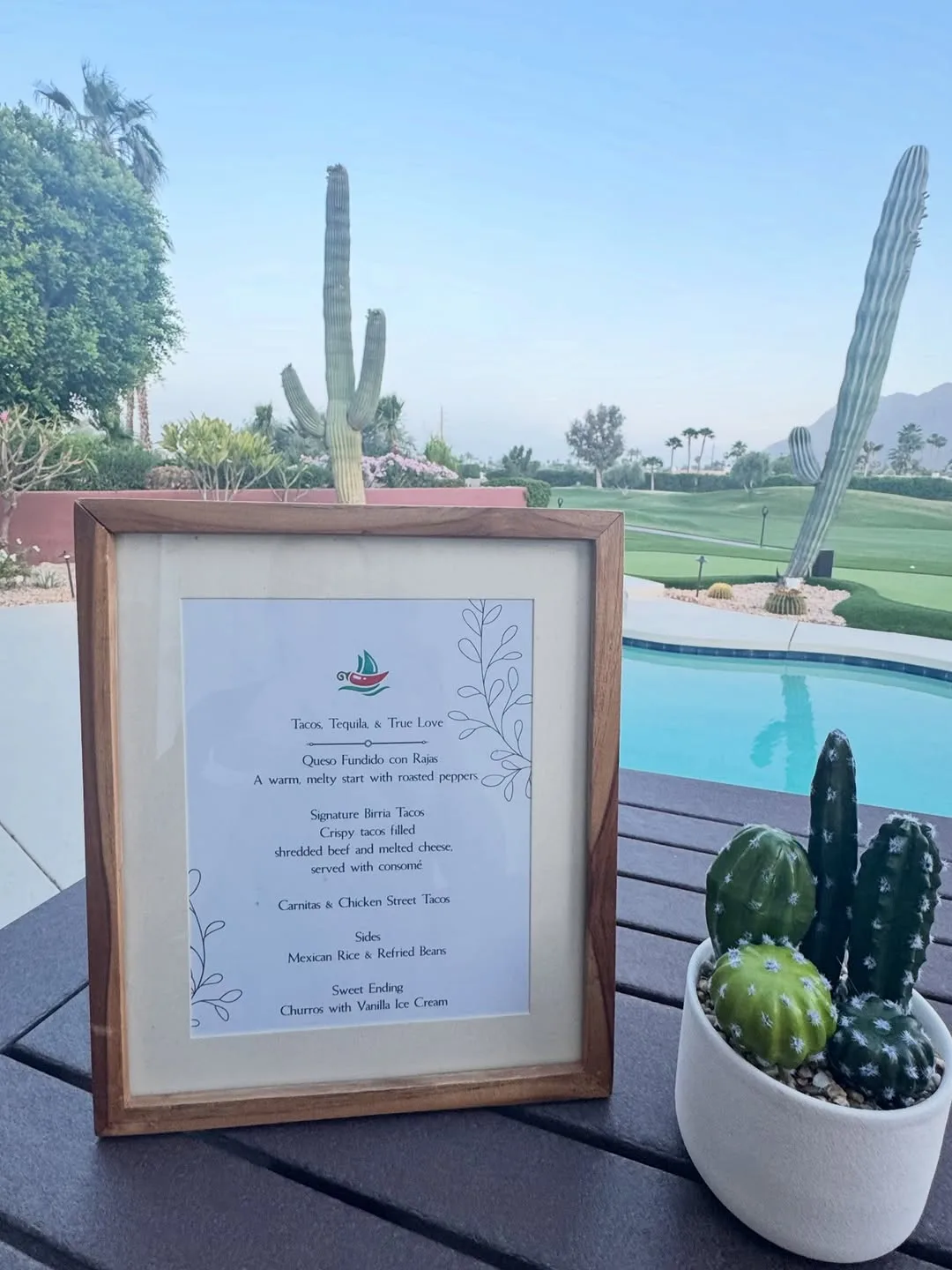 Framed TacoNTodo catering menu with desert cacti and a pool backdrop
