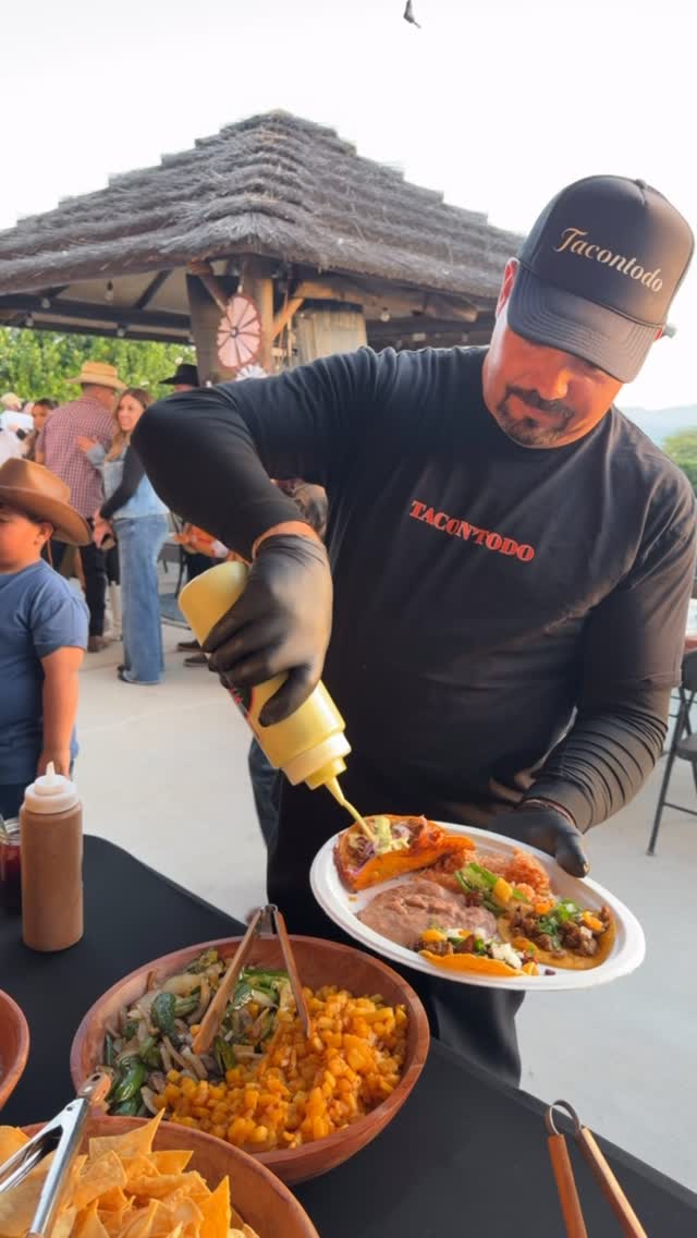 Omar serving tacos with signature salsas at an outdoor event