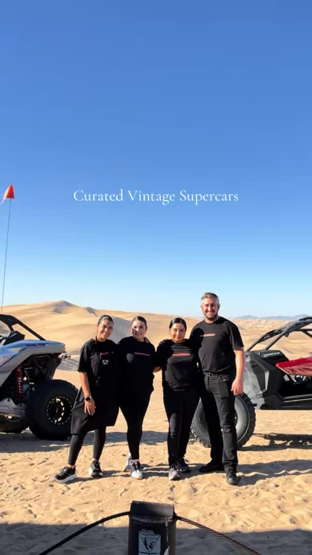 TacoNTodo team in the desert sand dunes with vintage cars